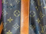 a close up of a louis vuitton handbag on a table