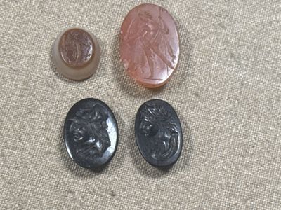 three different types of buttons sitting on top of a piece of cloth