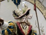 a figurine of a man with a hat and a sword