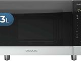 an image of a microwave oven with the door open and a clock on it