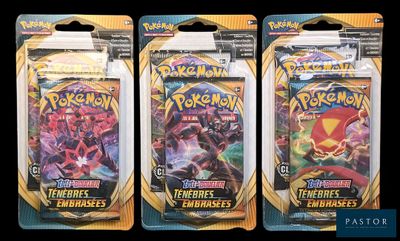 three packs of pokemon trading cards are shown on a black background