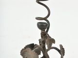 a metal candle holder that has a spiral design on it