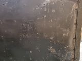 a picture of a dirty kitchen with a stove in the corner