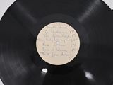 a black record with writing on it sitting on a table