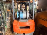 a forklift that is sitting in the dirt