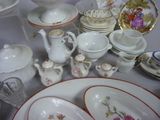 many plates and bowls and cups on the table