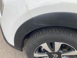 a close up of a tire on a white car