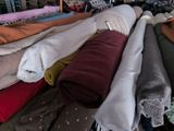 a lot of clothes that are sitting on a rack