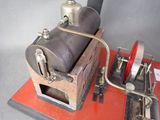 a model of a steam engine on a red platform