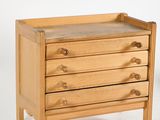 an image of a small wooden chest of drawers on a white background