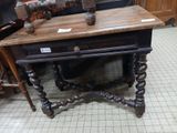 a wooden table with a drawer on it in a room