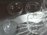 four empty wine glasses sitting on a table next to each other