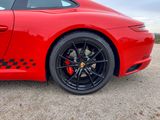 the red sports car is parked on the side of the road