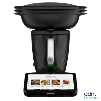 a black blender sitting on top of a tablet computer