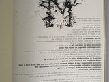 an open book with a picture of a tree on it