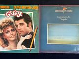 two lp ' s of the movie grease and grease, with a picture of a man holding a pencil