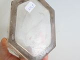 a person holding a glass container with a sticker on it