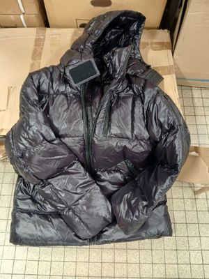 a black jacket sitting on top of a cardboard box