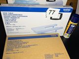 two boxes of paper and a can of glue on a desk