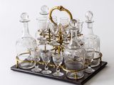 a tray with a lot of glasses and decanters on it