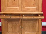 a wooden cabinet with two doors on top of it