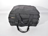 a black duffel bag sitting on a white surface