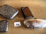 three different types of silver jewelry are displayed on a brown surface