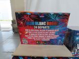 boxes of fireworks are sitting on the floor in front of a white curtain