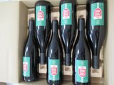 six bottles of red wine in a box with a stop sign on the label