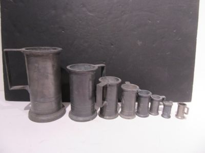 many different types of pewware sitting on a table