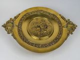 an image of a gold plate with a picture of a man riding a horse