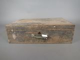 an old wooden box with a handle and a tag on it