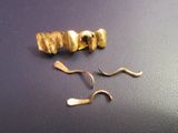 a pair of scissors and a gold earring on a table