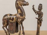 a statue of a horse and a man standing next to each other
