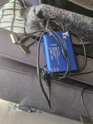 a blue power bank sitting on top of a gray couch