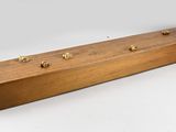 a wooden box with four brass knobs on top of it