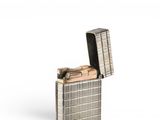 silver lighter with a lighter in the middle of it on a white surface