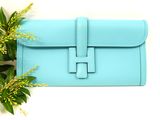 a blue purse with a flower on top of it