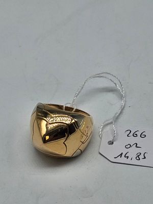 a gold bell on a white table with a price tag
