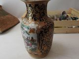a vase that is sitting on a table next to a box