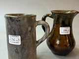 two vases sitting next to each other on a table