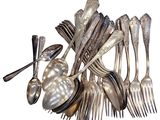 a lot of silver spoons and forks on the table