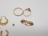 five pairs of gold rings and a pair of earrings