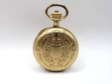 a close up of a gold pocket watch on a white background