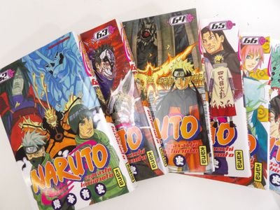 a lot of anime books that are on the table