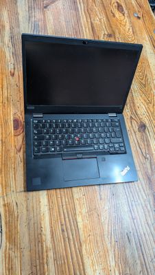 a laptop computer sitting on top of a wooden table