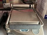 a toaster sitting on top of a counter next to a laptop