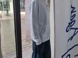 a mannequin wearing a pink hat in a store window