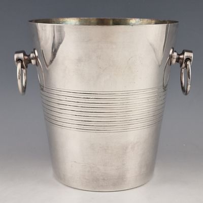 silver plated ice bucket with handles and handles on a grey background