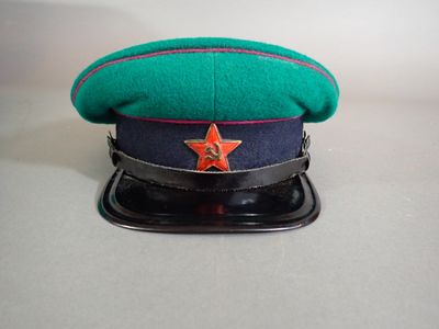 a green hat with a red star on top of it